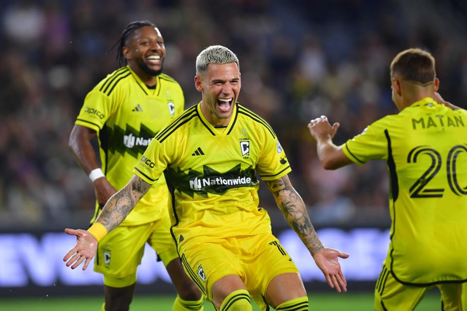 Jul 13, 2024; Los Angeles, California, USA; Columbus Crew forward Christian Ramirez (17) celebrates with midfielder Alexandru Matan (20) after scoring a goal in the second half against LAFC at BMO Stadium. Mandatory Credit: Gary A. Vasquez-USA TODAY Sports