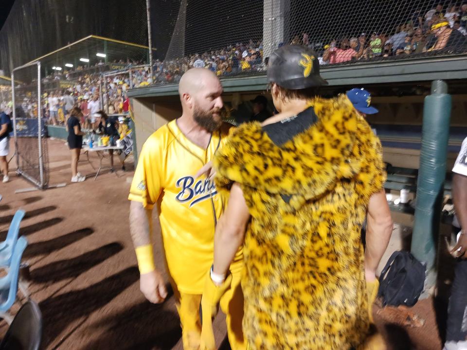 Jonny Gomes, left, is approached by Savannah Bananas Premier Team head coach Eric Byrnes after Gomes scored the winning run in the final inning of a victory over the Party Animals on Aug. 20 at Grayson Stadium. Byrnes and Gomes are former Major League Baseball players who have participated in Banana Ball games.