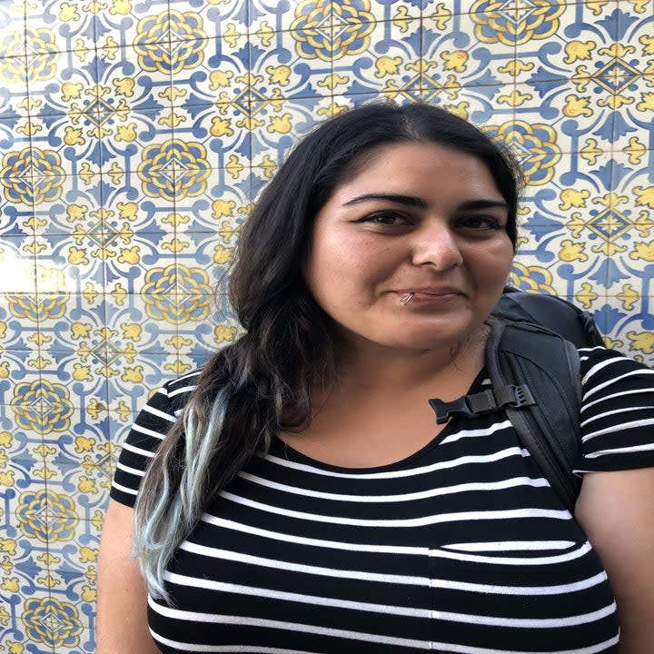 Posing in front of intricately painted tiles