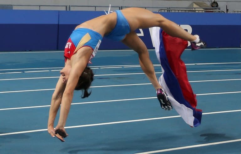 Russia's Yelena Isinbayeva somersaults after winning the women's pole vault final at the 2013 IAAF World Championships at the Luzhniki stadium in Moscow on August 13, 2013. Russia hailed the stunning triumph of pole vault queen Isinbayeva, hoping her victory would not mark the culmination of an illustrious career