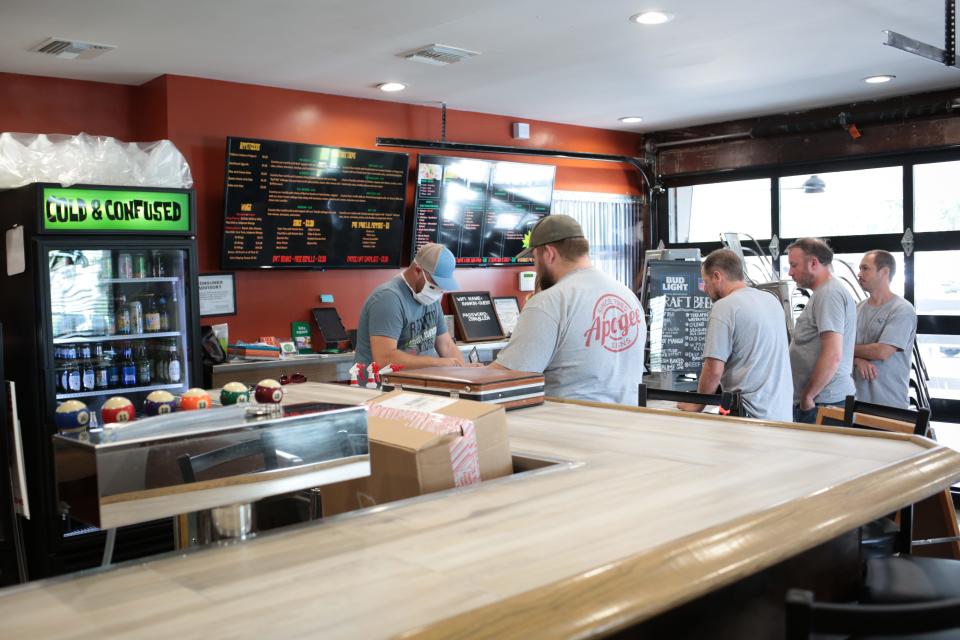 Roger Rankin takes orders during Tuesday’s lunch rush at his restaurant, Rankin Tacos.