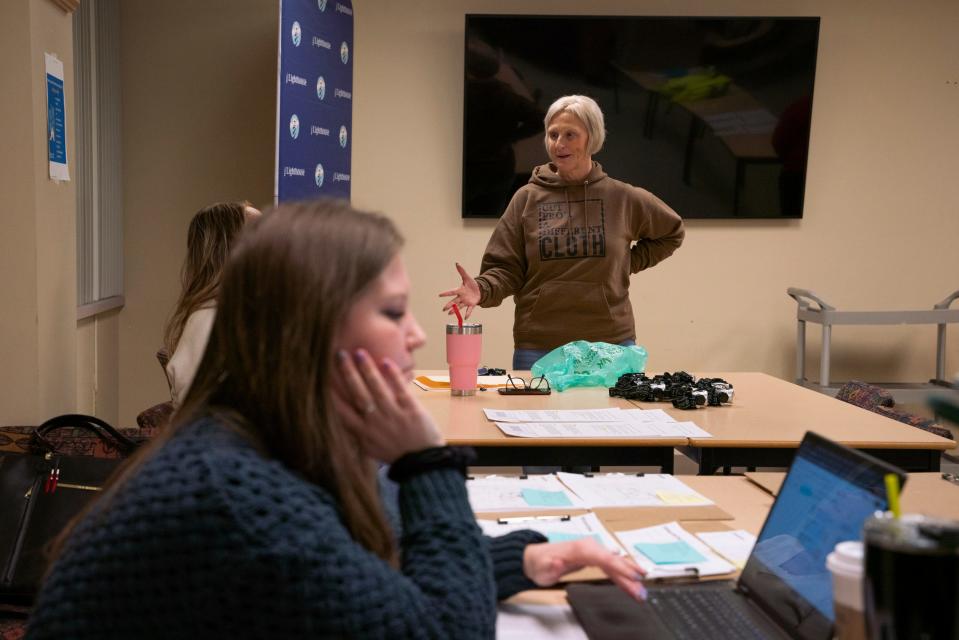 Lighthouse director of housing and community development Shannon Smith, 46, of Waterford, right, talks with people before the annual Point-in-Time (PIT) count at the Lighthouse headquarters in Pontiac on Jan. 30, 2023.