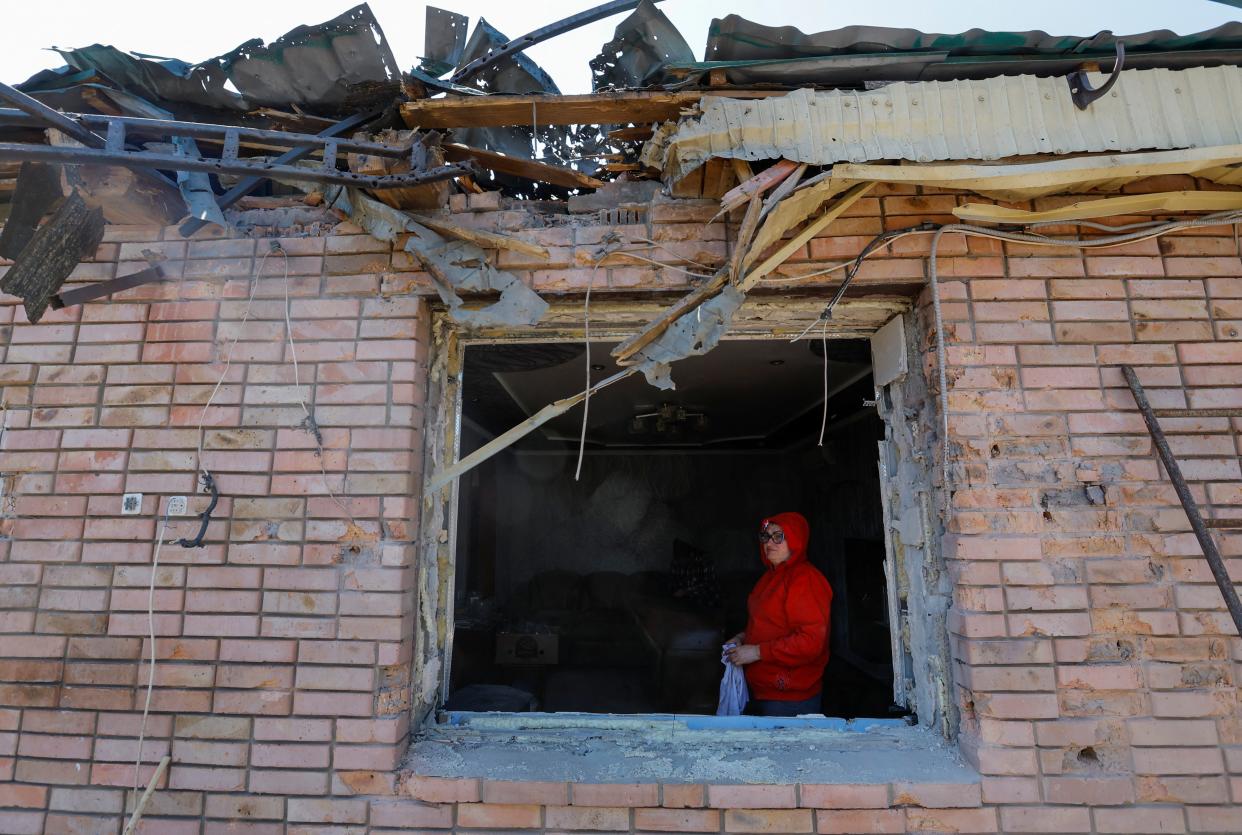 Local resident Julia Cozlova, 55, looks out of her house, which was damaged by recent shelling in the course of Russia-Ukraine conflict, in the town of Horlivka (Gorlovka) in the Donetsk region (REUTERS)
