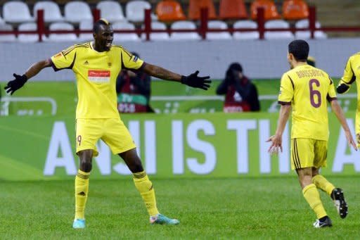 FC Anzhi Makhachkala's Lacina Traore (L) celebrates with Mbark Boussoufa after scoring a goal during their UEFA Europa League group A football match in Moscow. Anzhi Makhachkala moved to the top of Europa League Group A as they leapfrogged Liverpool with a 1-0 win thanks to a lone Traore goal in freezing temperatures in Moscow