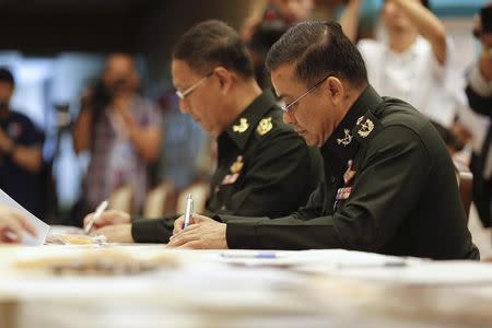 Newly appointed National Legislative Assembly members sign documents during a registration session at the Parliament House in Bangkok August 1, 2014. REUTERS/Athit Perawongmetha