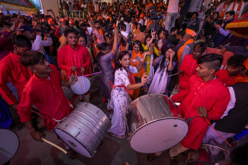 Bharatiya Janata party (BJP) supporters celebrate early leads for the party as vote counting of Gujarat state elections is underway in Gandhinagar, India, Thursday, Dec. 8, 2022. The local elections in Prime Minister Narendra Modi's home state is seen as a barometer of his ruling Bharatiya Janata party’s popularity ahead of a general election in 2024. (AP Photo/Ajit Solanki)