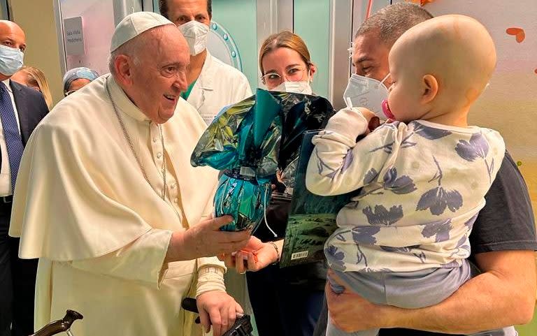 In this image made available by Vatican Media, Pope Francis brings Easter eggs to the young patients of the pediatric oncology ward, Friday, March 31, 2023 inside the Agostino Gemelli University Hospital where he is treated since Wednesday for a bronchitis. Francis is expected to be discharged on Saturday. (AP Photo/Vatican Media) - AP Photo/Vatican Media