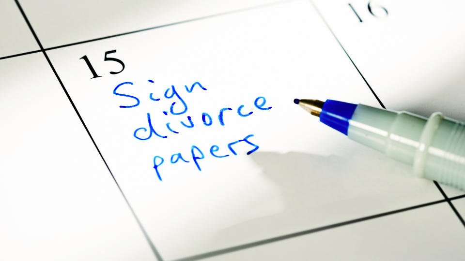 A non-specific calendar has the words 'Sign divorce papers' written in blue.