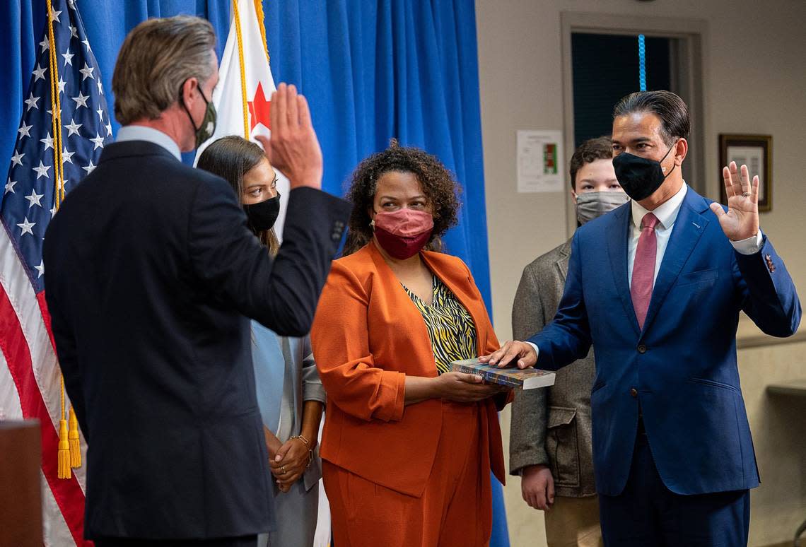 Now-Assemblywoman Mia Bonta, D-Oakland, stands alongside her husband, Attorney General Rob Bonta, as Gov. Gavin Newsom swears him in during a ceremony in April 2021.