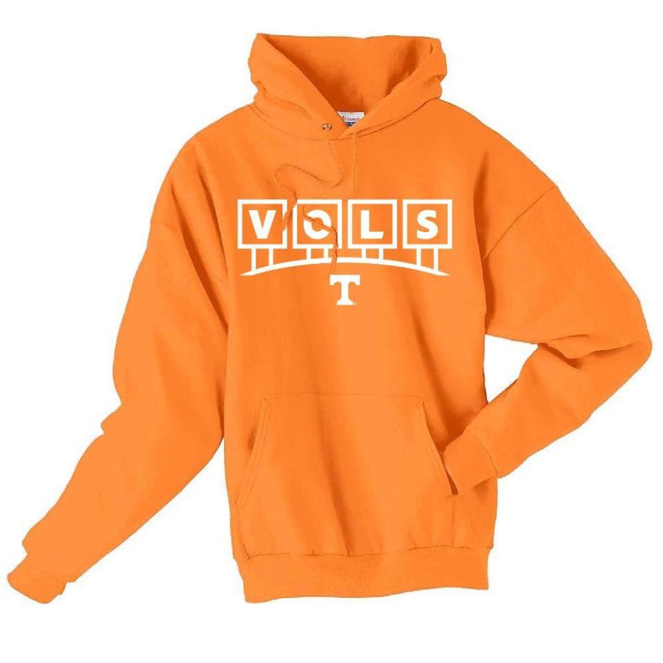 A Tennessee Volunteers hoodie featuring the V-O-L-S signs atop Neyland Stadium. It's sold at Alumni Hall.