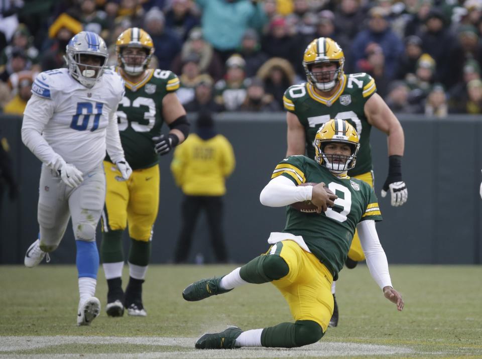 Green Bay Packers' DeShone Kizer slides after running for a first down during the second half of an NFL football game against the Detroit Lions Sunday, Dec. 30, 2018, in Green Bay, Wis. (AP Photo/Mike Roemer)