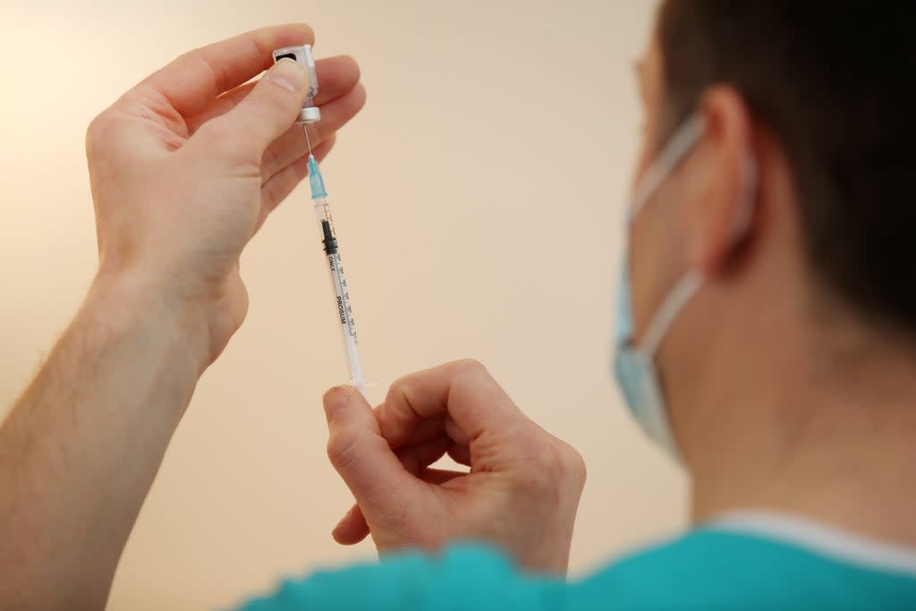 A doctor prepares to administer a coronavirus vaccine (Nick Potts/PA) (PA Archive)