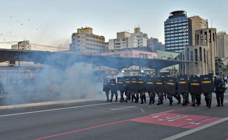 Police fire tear gas against striking subway workers and members of the MTST (Homeless Workers' Movement) demonstrating in Sao Paulo, Brazil on June 9, 2014