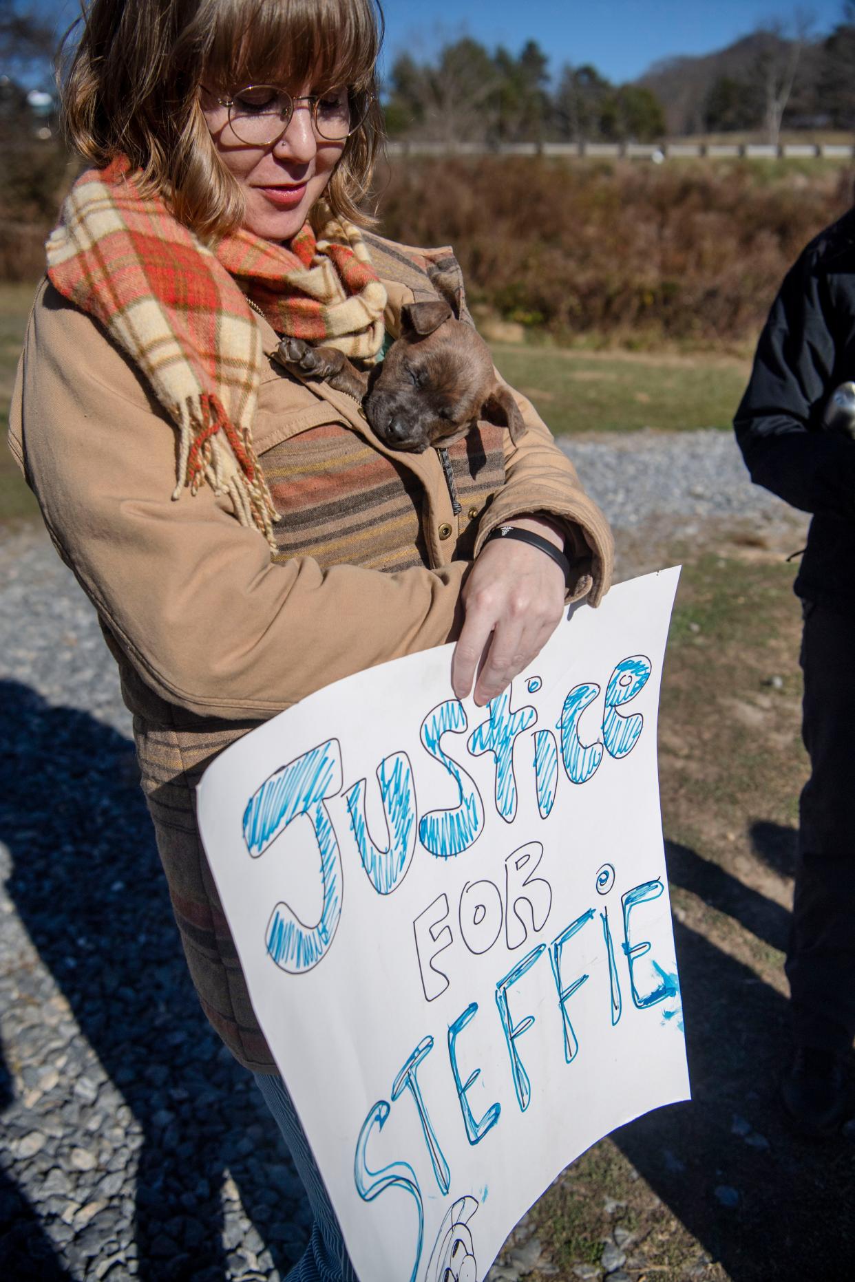 Ashley Merchant holds a Misfit Mountain puppy, Catherine, while showing support for Steffie, a dog that was shot and killed by a Henderson County Sheriff’s deputy.