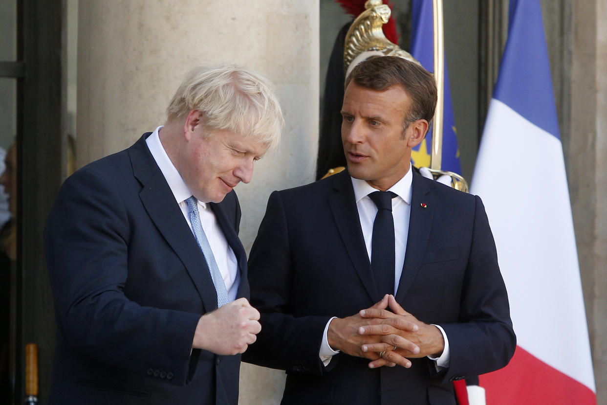 French President Emmanuel Macron, right, and Britain's Prime Minister Boris Johnson leave after their talks at the Elysee Palace, Thursday, Aug. 22, 2019 in Paris. Boris Johnson traveled to Berlin Wednesday to meet with Chancellor Angela Merkel before heading to Paris to meet with French President Emmanuel Macron. (AP Photo/Michel Spingler)