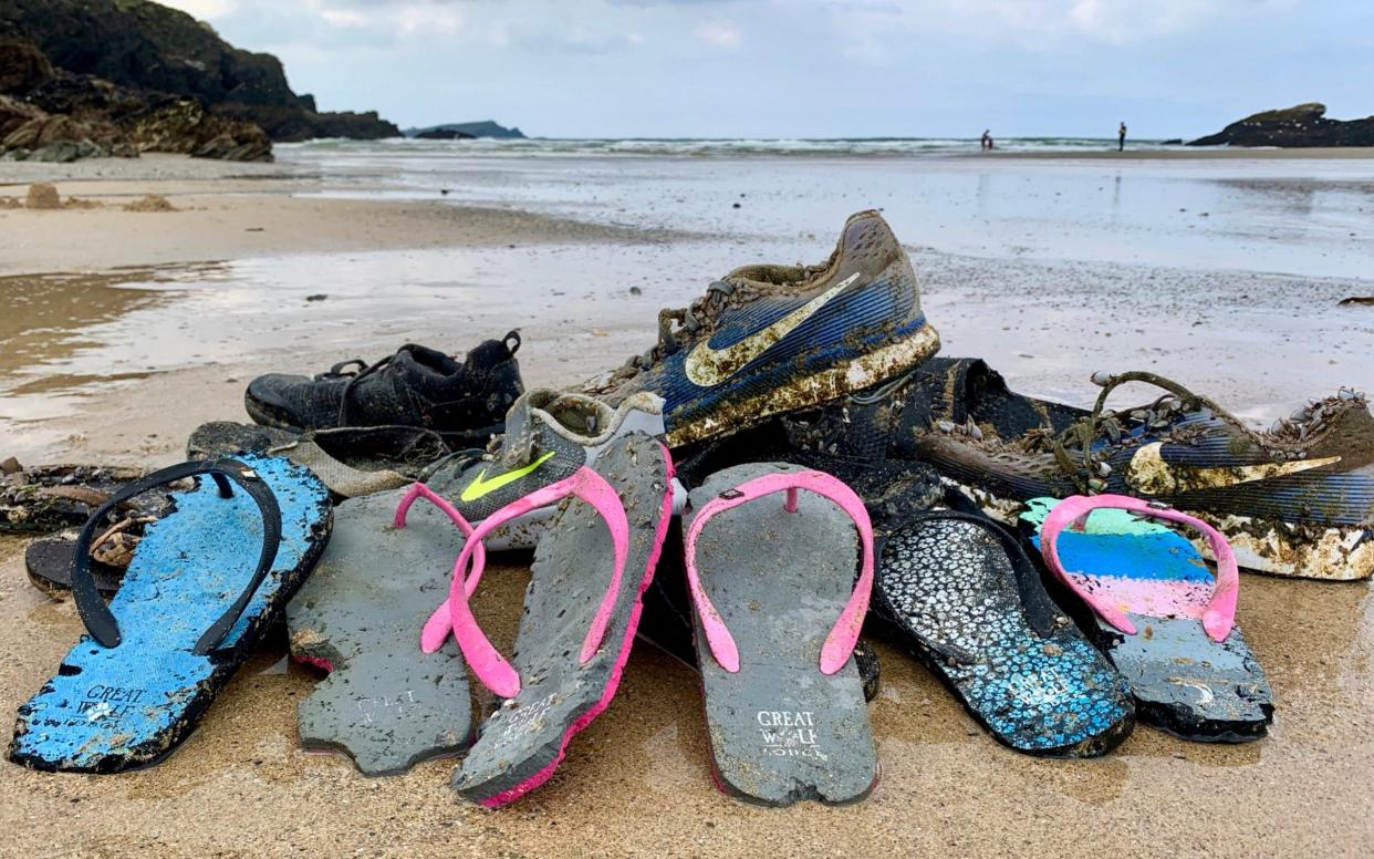 Hundreds of Nike trainers and flip flops have been washed up on beaches across the world, including in Cornwall - Tracey Williams / SWNS