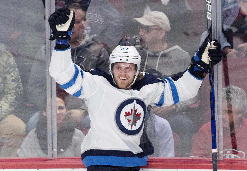 Winnipeg Jets' Nikolaj Ehlers celebrates after scoring against the Montreal Canadiens during second-period NHL hockey game action in Montreal, Monday, Jan. 6, 2020. (Graham Hughes/The Canadian Press via AP)