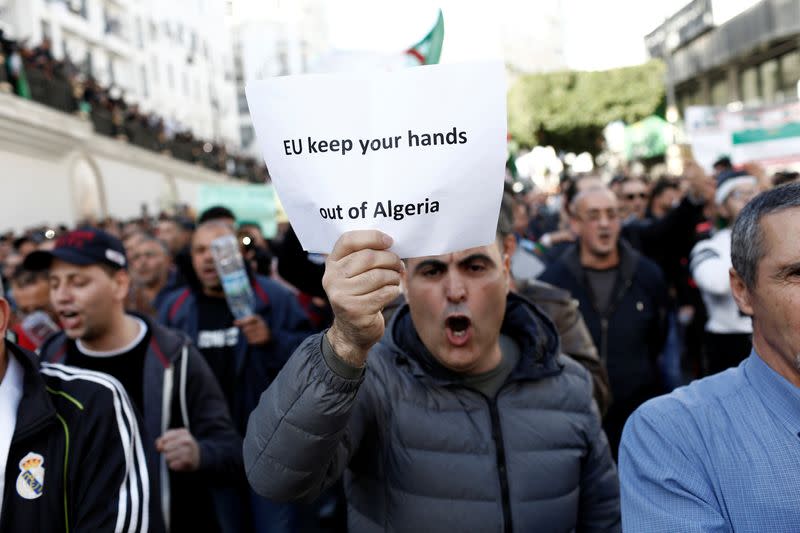 Demonstrators take part in a protest to demand for the presidential election scheduled for next week to be cancelled, in Algiers