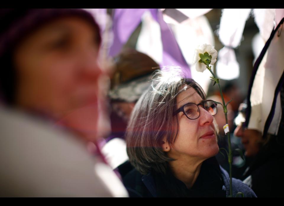 NEW YORK - MARCH 25:  Erica Lasner (R), whose great aunt Fannie Lasner perished in the blaze, holds a flower at a ceremony at the site of the Triangle Shirtwaist Factory fire March 25, 2011 in New York City. The ceremony marked the 100 year anniversary of the fire which killed 146 immigrant workers, most of them young women. Workers were locked into the factory during their shifts, preventing escape. New Yorkers watched in horror from below as workers leapt to their deaths from the windows above. Public outcry over the tragedy led to nationwide debate on workers rights and safety regulations and helped pave the way for strong workers unions. (Photo by Eric Thayer/Getty Images)