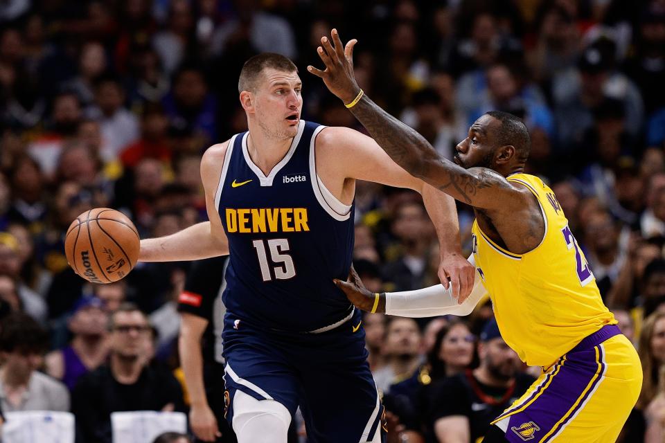 Nuggets center Nikola Jokic (15) controls the ball under pressure from Lakers forward LeBron James (23) during the first quarter of Game 5 of their first round NBA playoff series at Ball Arena in Denver on April 29, 2024.