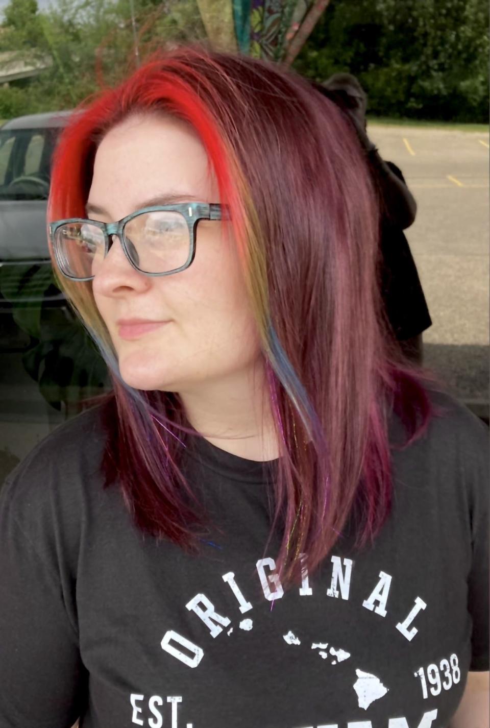 Kathyryne Hines shows off her rainbow strip of hair done by Malakai's Mirror salon owner and boyfriend, Malakai Ellis.