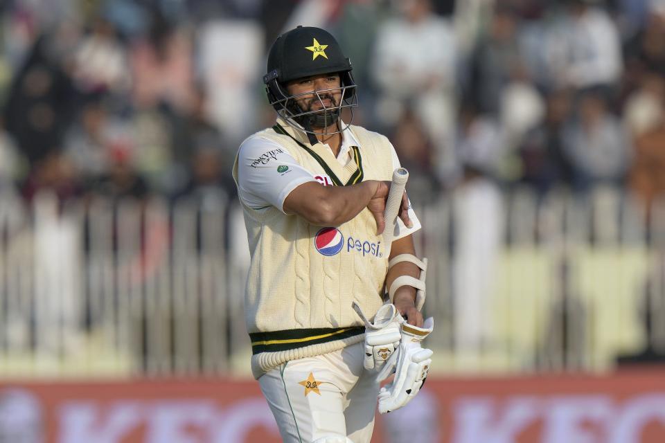 Pakistan's Azhar Ali reacts as he walks off the field after his dismissal during the fifth day of the first test cricket match between Pakistan and England, in Rawalpindi, Pakistan, Monday, Dec. 5, 2022. (AP Photo/Anjum Naveed)