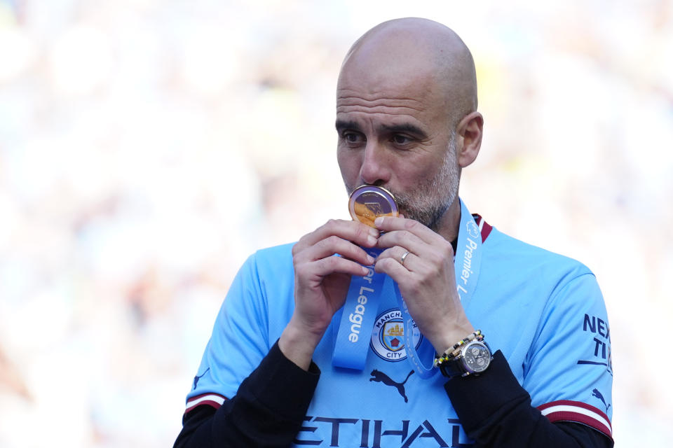 Manchester City's head coach Pep Guardiola celebrates Premier League title after the English Premier League soccer match between Manchester City and Chelsea at the Etihad Stadium in Manchester, England, Sunday, May 21, 2023. (AP Photo/Jon Super)