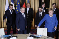 French President Emmanuel Macron, second left, Russian President Vladimir Putin, left, German Chancellor Angela Merkel and Ukrainian President Volodymyr Zelenskiy,second right, arrive for a working session at the Elysee Palace Monday, Dec. 9, 2019 in Paris. Russian President Vladimir Putin and Ukraine's president are meeting for the first time at a summit in Paris to find a way to end the five years of fighting in eastern Ukraine. (AP Photo/Thibault Camus, Pool)