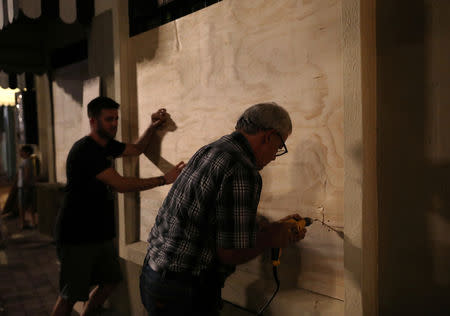 People board up windows of a store as Hurricane Willa approaches the Pacific beach resort of Mazatlan, Mexico October 22, 2018. REUTERS/Henry Romero