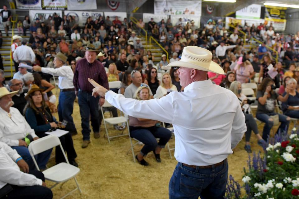 Ringman Shawn Hagler points to a bidder during the Junior Livestock Auction at the Ventura County Fair in 2022.