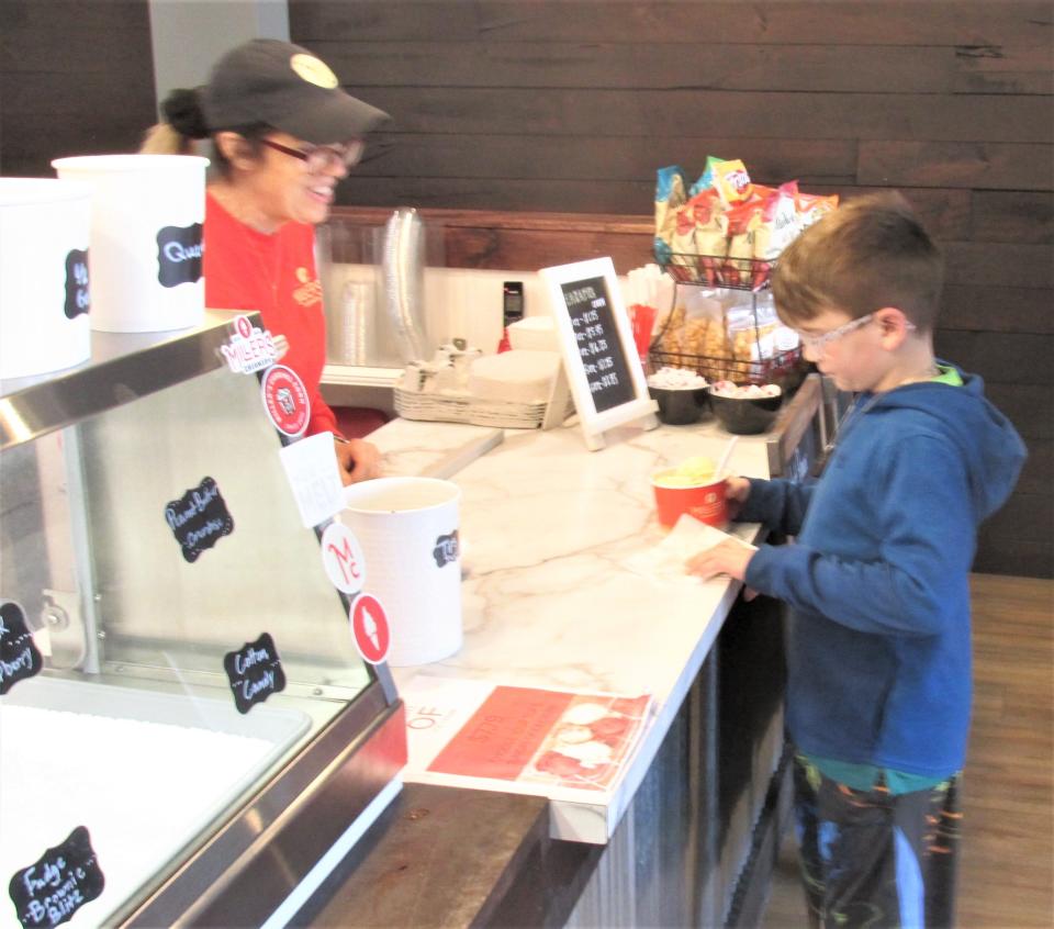 Sterling Weaver gets a cup of vanilla bean ice cream at Miller's Creamery in MIllersburg.