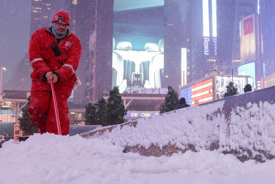 A worker clears snow in Times Square.