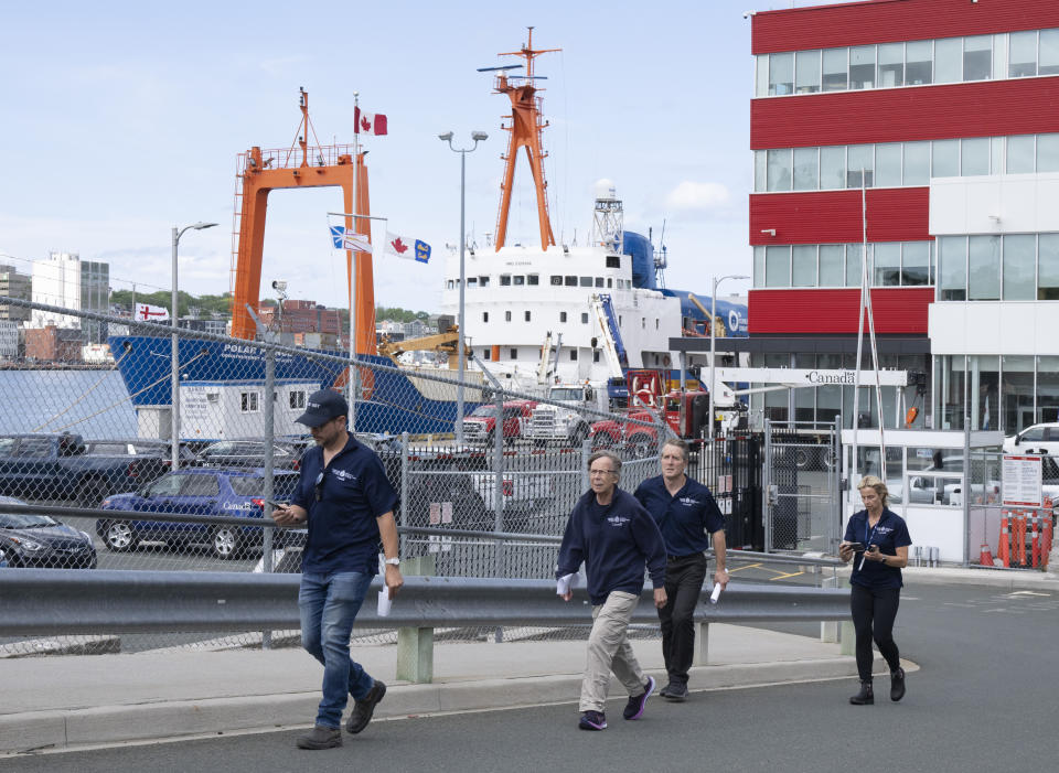 The Polar Prince is docked behind them as Transportation Safety Board Chair Kathy Fox, second left, walks out with TSB members including TSB investigator Cliff Harvey, third left, walk to a news conference on Saturday, June 24, 2023 in St. John's, Newfoundland. Authorities from the U.S. and Canada began the process of investigating the cause of the fatal Titan submersible implosion even as they grappled with questions of who was responsible for determining how the tragedy unfolded. (Adrian Wyld /The Canadian Press via AP)