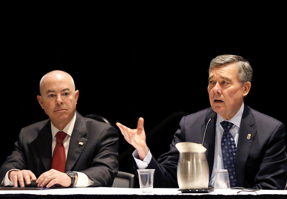 R. Gil Kerlikowske, Commissioner, U.S. Customs and Border Protection, speaks as Alejandro Mayorkas, Deputy Secretary, Dept. of Homeland Security, listens, at the opening of the 8th annual Border Security Expo, Tuesday, March 18, 2014 in Phoenix. The two day event will feature panel discussions, sharing intelligence, and exhibitors displaying high-tech wares aimed at securing lucrative government contracts and private sales. (AP Photo/Matt York)