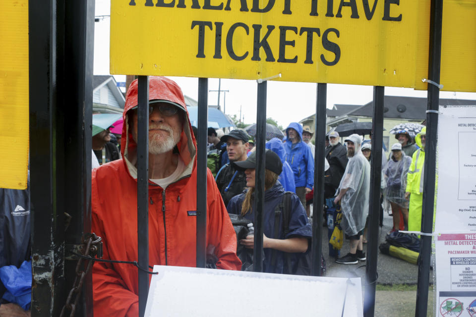 Richard Ashmore, of Kenner, La, waits for the gates to open at the New Orleans Jazz & Heritage Festival New Orleans, Thursday, April 25, 2019. The opening was delayed by heavy rain. (AP Photo/Doug Parker}