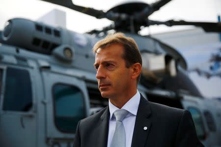 Airbus Helicopters CEO Guillaume Faury stands near a multi-role military helicopter EC 725 by Airbus Helicopters at an international military fair in Kielce, southern Poland September 2, 2014. REUTERS/Kacper Pempel