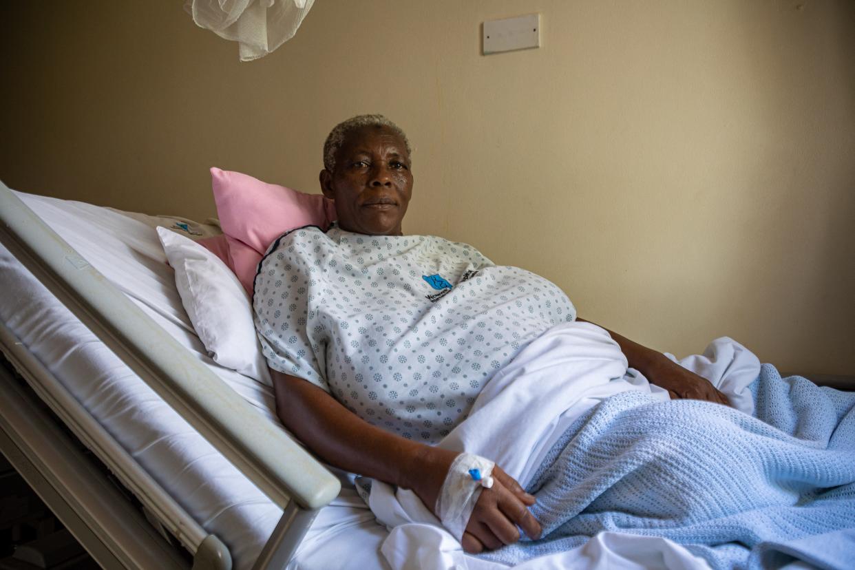 Safina Namukwaya, 70, sits on a hospital bed at the Women's Hospital International and Fertility Centre after giving birth in Kampala on December 03, 2023. Namukwaya gave birth to twins on November 29 at a medical facility in the Ugandan capital, where she had received fertility treatment.