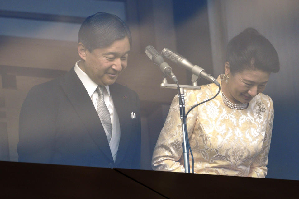 Japan's Emperor Naruhito bows with Empress Masako to well-wishers from the bullet-proofed balcony during a public appearance with his imperial families at Imperial Palace in Tokyo Thursday, Jan. 2, 2020, in Tokyo. (AP Photo/Eugene Hoshiko)