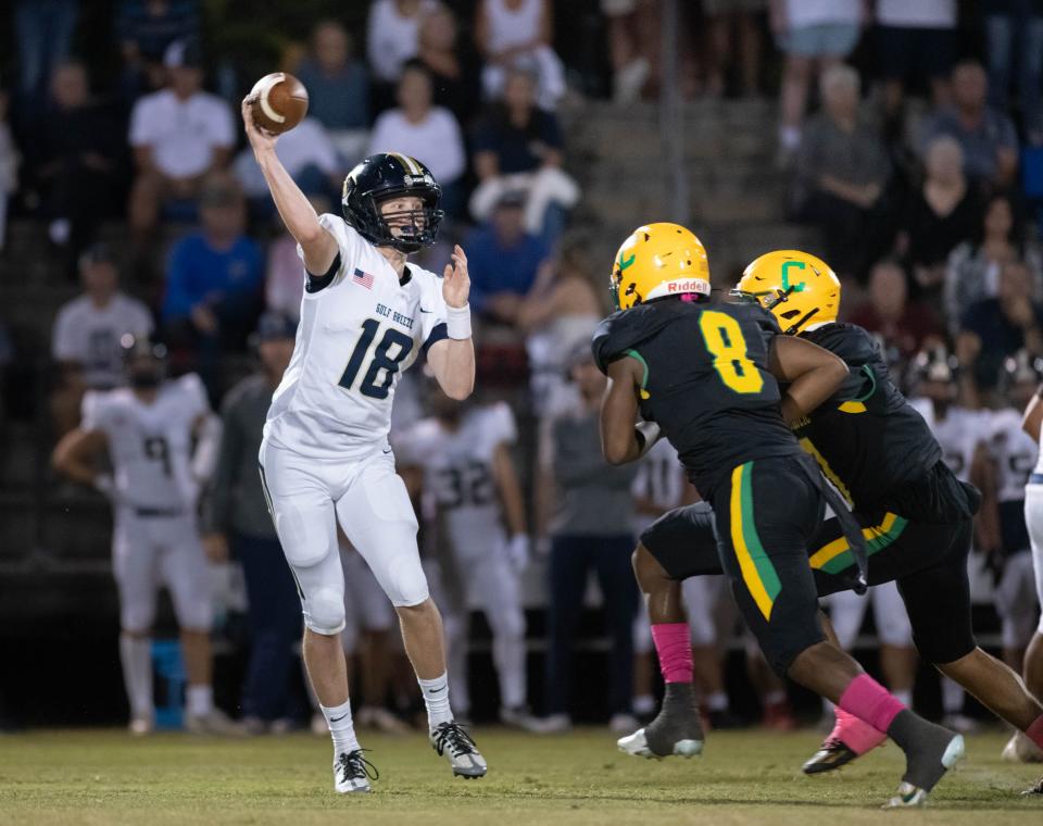 Quarterback Battle Alberson (18) passes during the Gulf Breeze vs Catholic football game at Pensacola Catholic High School in Pensacola on Thursday, Oct. 6, 2022.