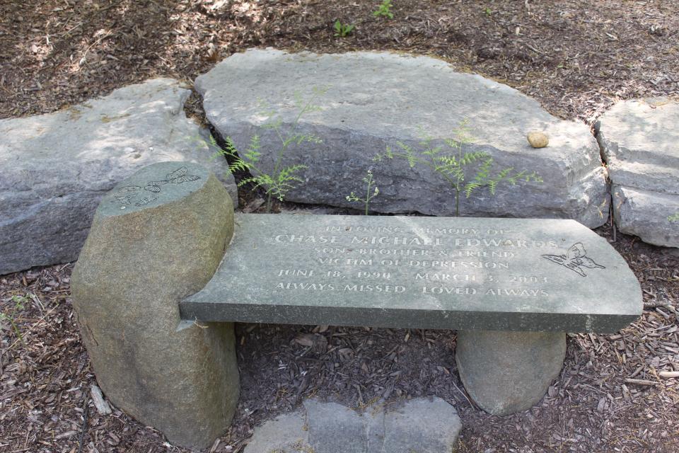 A memorial bench located beside a Little Free Library placed to honor Chase Michael Edward.