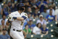 Milwaukee Brewers' Christian Yelich hits an RBI sacrifice fly during the seventh inning of a baseball game against the Pittsburgh Pirates Sunday, June 13, 2021, in Milwaukee. (AP Photo/Aaron Gash)