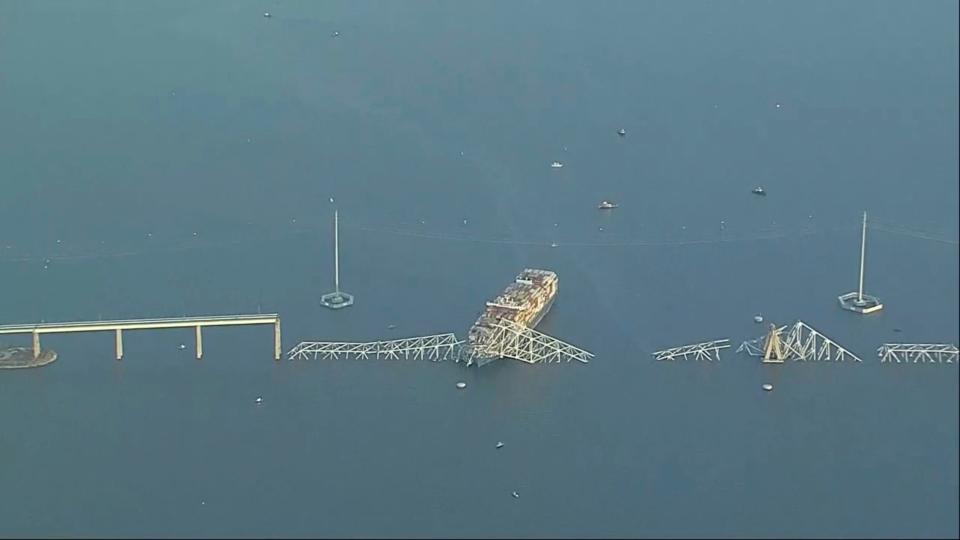 Parts of the Francis Scott Key Bridge remain after a container ship collided with a support Tuesday, March 26, 2024 in Baltimore. The major bridge in Baltimore snapped and collapsed after a container ship rammed into it early Tuesday, and several vehicles fell into the river below. Rescuers were searching for multiple people in the water. (WJLA via AP)