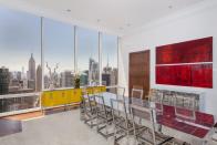 <p>The modern dinning area, with its high ceilings and elegant decor, is seen here. (Corcoran) </p>