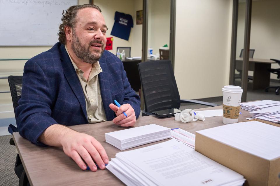 Sam Stone grabs a pen and prepares to start addressing letters on Jan. 12, 2023, as part of his campaign for the seat representing District 6 of Phoenix.