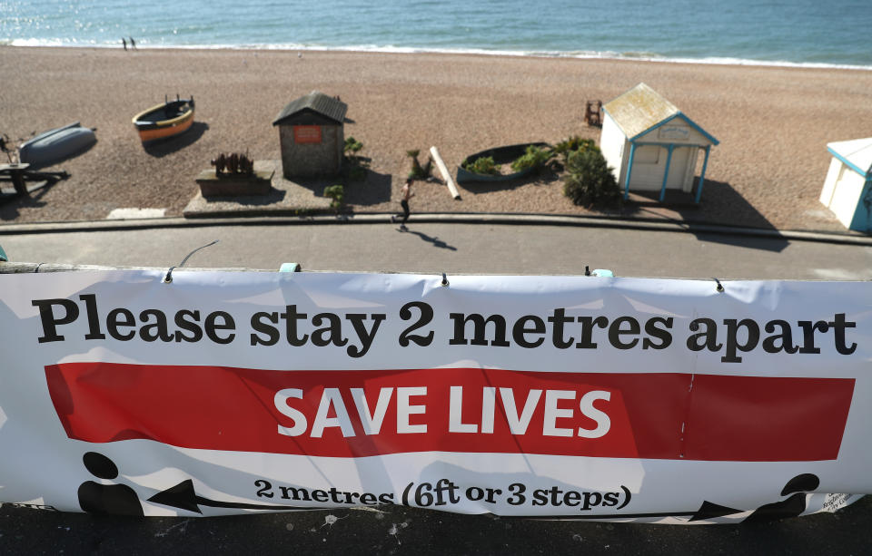 A 'Please stay 2 metres apart' sign on Brighton beach, as the UK continues in lockdown to help curb the spread of the coronavirus.