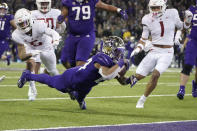 Washington running back Kamari Pleasant dives for a touchdown against Washington State during the first half of an NCAA college football game, Friday, Nov. 26, 2021, in Seattle. (AP Photo/Ted S. Warren)