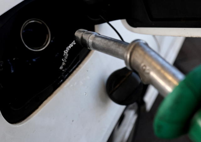 A car is filled with petrol at a filling station, in Knutsford, Cheshire, Britain, March 10, 2022. REUTERS/Carl Recine