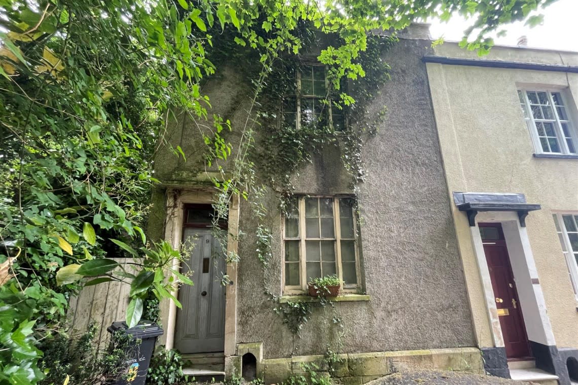 The home is covered in overgrown ivy, has no stairs and a fallen in ceiling and has been vacant for five years. (SWNS)