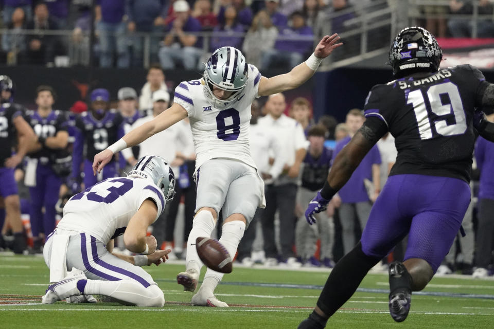 Kansas State's Ty Zentner kicks a field goal past TCU linebacker Shadrach Banks (19) in overtime of the Big 12 Conference championship NCAA college football game, Saturday, Dec. 3, 2022, in Arlington, Texas. Holding is Jack Blumer. (AP Photo/LM Otero)