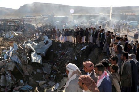 People gather at the site of an air strike in the northwestern city of Saada, Yemen November 1, 2017. REUTERS/Naif Rahma